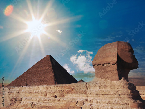 Egyptian Great Sphinx full body portrait with head  feet with all pyramids of Menkaure  Khafre  Khufu in background on a clear  blue sky day in Giza  Egypt empty with nobody. copy space 