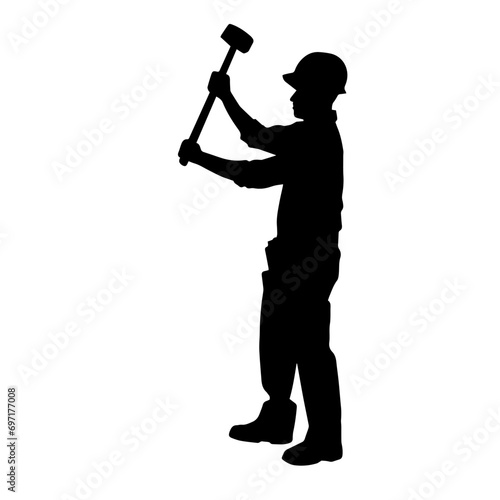 Silhouette of a worker in action pose using his sledge hammer tool.
