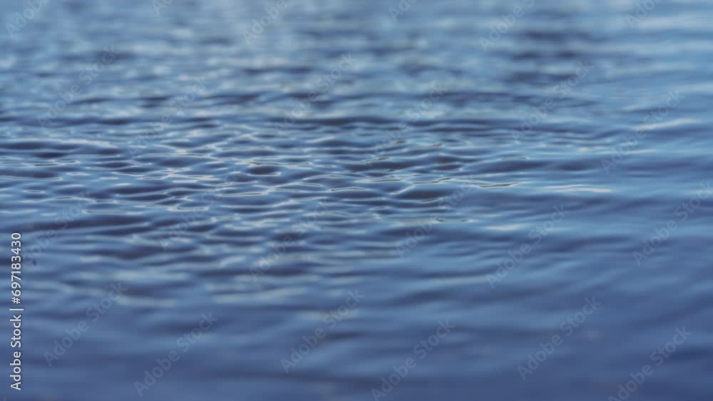Wind ripples on the blue water surface. Slow motion. Wind ripples on the blue water surface. Slow motion.