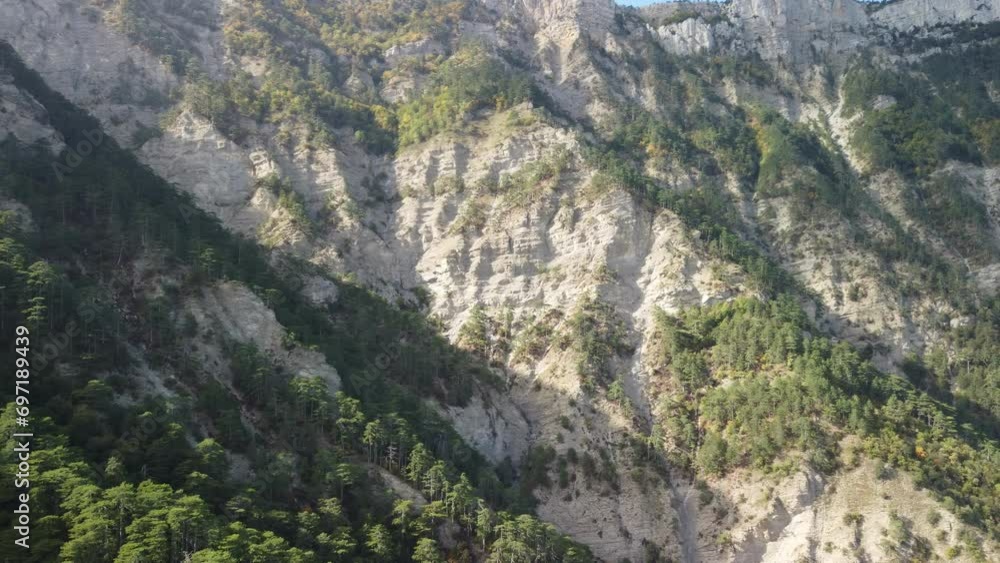 Aerial panoramic view of forest on rocky mountain slope - Ai Petri, Yalta, Crimea. Abstract aerial nature forest and mountains. Weather and Climate Change. Vacation, travel and holiday concept Aerial panoramic view of forest on rocky mountain slope - Ai Petri, Yalta, Crimea. Abstract aerial nature forest and mountains. Weather and Climate Change. Vacation, travel and holiday concept