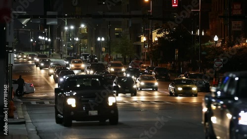 Baltimore Evening City Street. Cars are Turning Left, Daily Traffic and Street Lights in Background. Maryland State photo