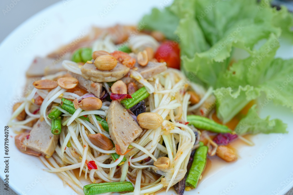 Thailand local food. Green papaya salad or Som Tum in white plate. . Somtum, Delicious and tradition Thai foods. Thailand local food. Green papaya salad or Som Tum in white plate. . Somtum, Delicious and tradition Thai foods.