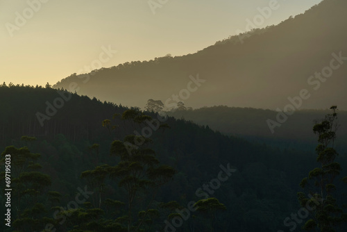 Aerial view of beautiful natural scenery for mountain in fog, clouds, sun rays rainforest in Indonesia © dera