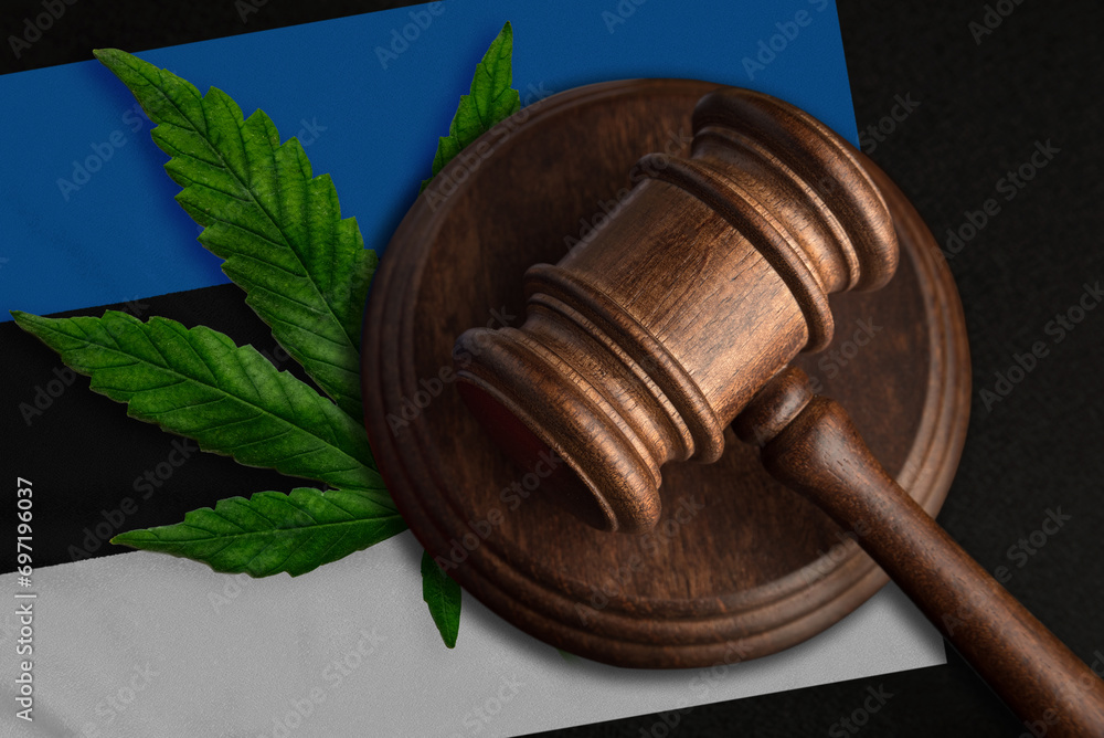 Flag of Estonia and justice wooden gavel with cannabis leaf. Illegal growth of cannabis plant and drugs spreading
