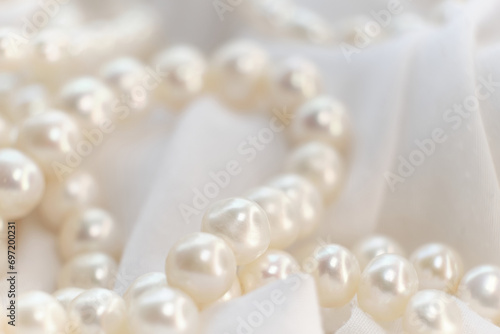 The soft glow of pearls on a white cloth paints a picture of gentle elegance. It's a nostalgic recall to authentic beauty, often overshadowed by today's digital alterations.