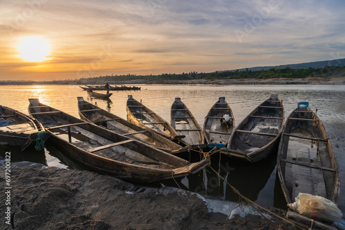 Landscape view of wooden boats on river bank at sunset, Jaflong, Bangladesh photo