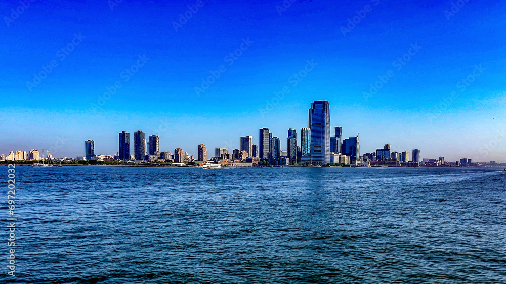 The fabulous skyline of New York, seen from a boat that has sailed to Liberty Island, where the fabulous Statue of Liberty of the Big Apple in the USA is located.