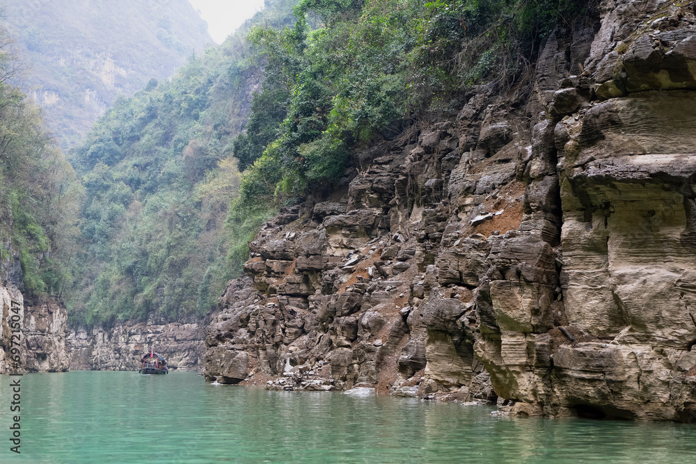 The Three Gorges of the Yangtze River are quiet and charming, with majestic peaks, clear river water and shrouded clouds. Trail on the mountain wall.