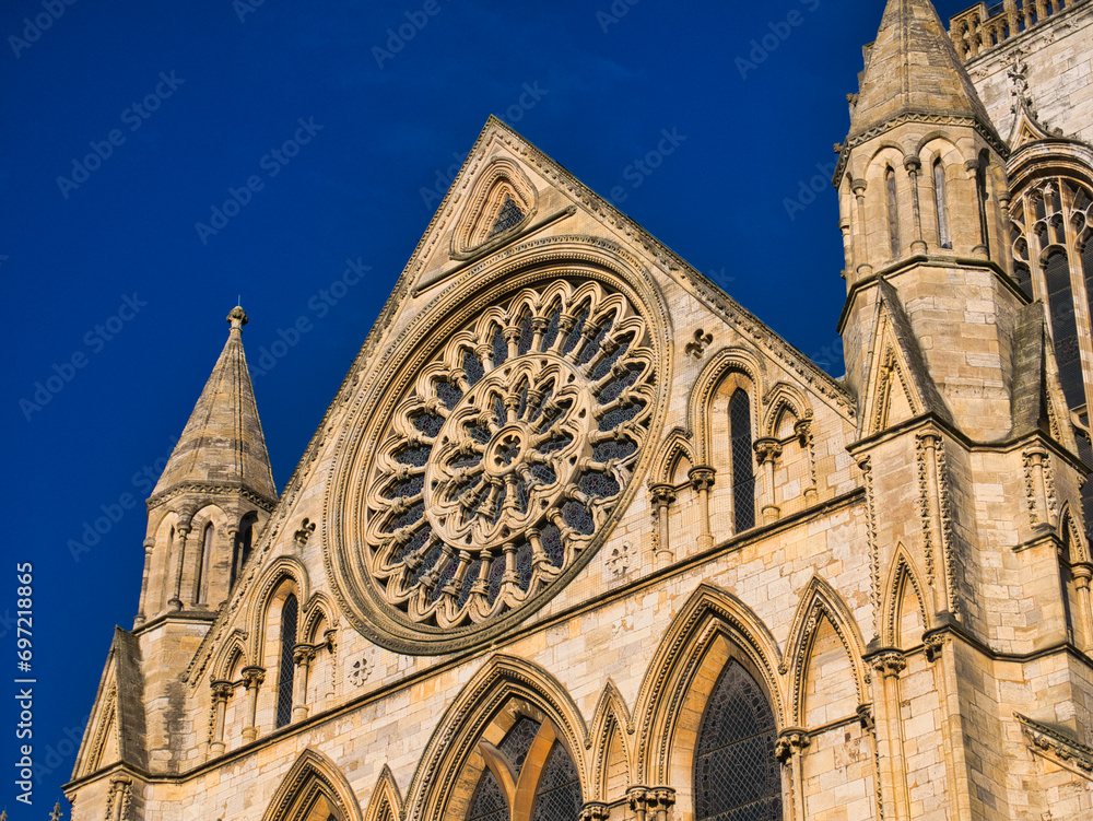 York, UK - Nov 24 2023: The circular Rose Window over the South Door in the South Transept of York Minster in northern England, UK. Taken on a sunny day with a blue sky.