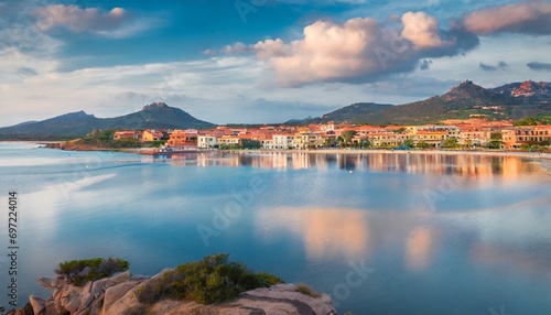 palau town with sciumara beach reflected in the calm waters of mediterranean sea province of olbia tempio italy europe calm summer view of sardinia island vacation concept background