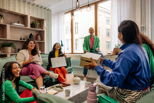 Happy female entrepreneurs having fun during business meeting at workplace photo