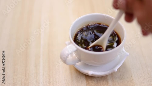 Hand making black coffee on a wooden table. Making coffee at home.