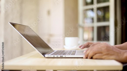 Working woman typing on laptop keyboard and closing the lid
