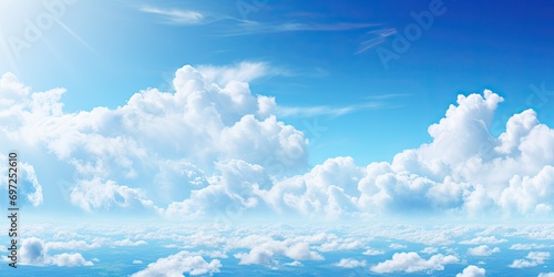 Beauty of summer sky with scattering of fluffy white clouds against backdrop of bright blue. Scene exudes tranquility and making ideal for aim to evoke calm and peaceful atmosphere