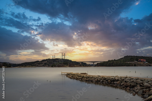 Landscape shot on a coast in winter with a view of the Tjörnbron cable bridge in the bay of Stenungsund in Sweden photo