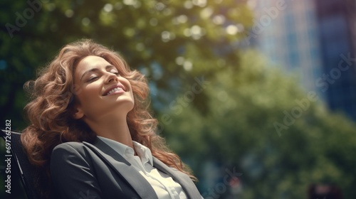 Businesswoman in a city park, smiling as she takes a break and enjoys the fresh air amidst a busy day photo