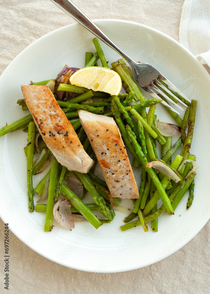 plate of fried tuna fillet with asparagus on the table plate of fried tuna fillet with asparagus on the table