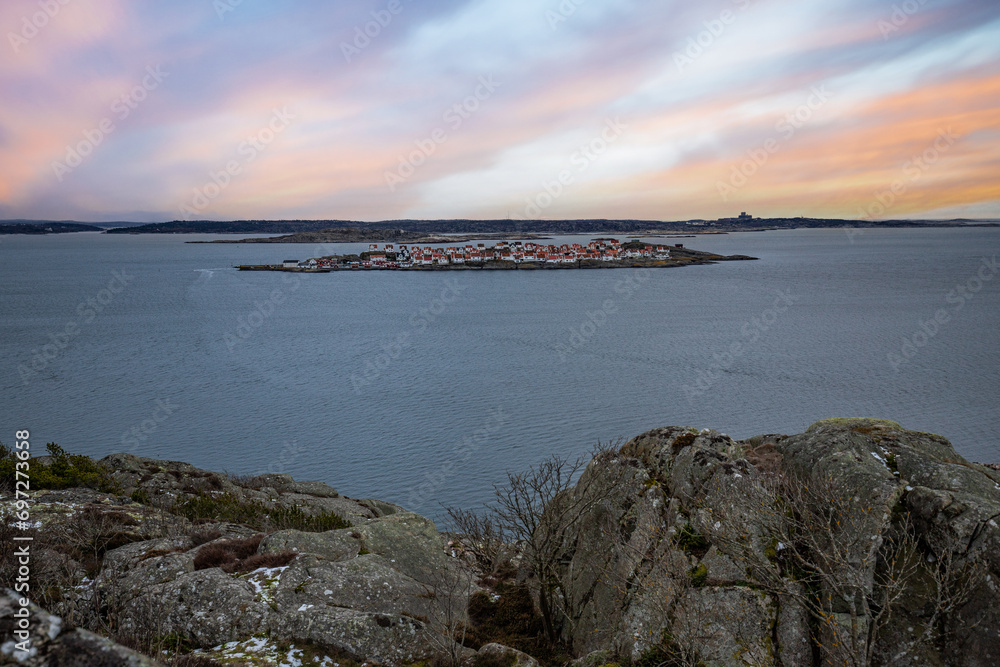 Landscape shot with a view of an island. Taken from a barren rock, you can see over the coast and the sea to the small island of Astol, Rönnäng, Sweden, which is built with typical Swedish houses