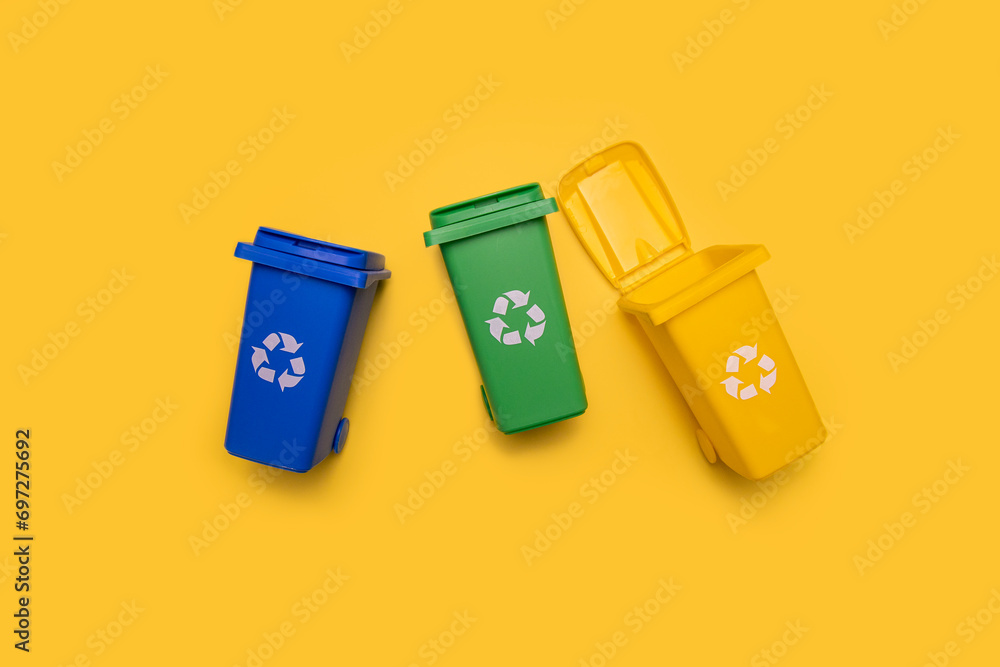 Garbage cans on a yellow background. Flat lay, top view Garbage cans on a yellow background. Flat lay, top view