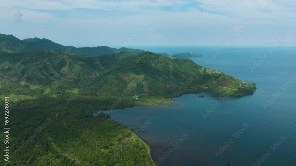 Aerial view of Tropical Island and blue sea with blue sky and clouds. Mindanao, Philippines. Aerial view of Tropical Island and blue sea with blue sky and clouds. Mindanao, Philippines.