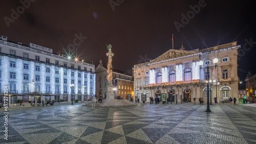 Panorama showing Municipal square with City Hall architecture decorated for Christmas and night celebrations night timelapse. People walking around. Lisbon, Portugal