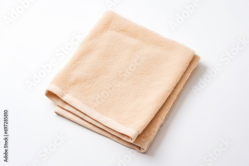 a folded towel on a white surface