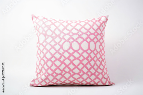 a pink and white pillow with a geometric design