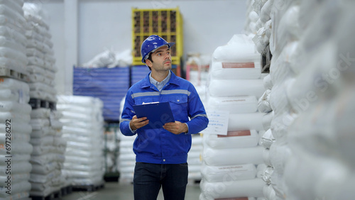 Worker checking inventory of a manufacturing company at Plastic factory.