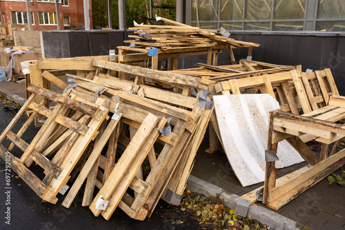 Disassembled Wooden Crate with Stacked Planks on Construction Site
