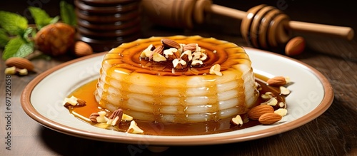 Arab dessert: Awameh, served with honey and nuts on a white plate.