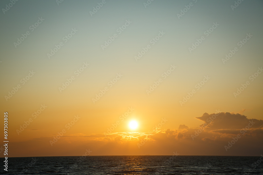 Beautiful sunset near the shore on the sea, background with sunset, orange sunset