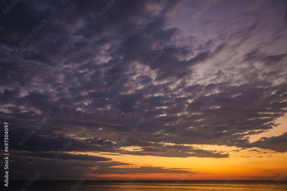 Beautiful sunset near the shore on the sea, background with sunset, orange sunset