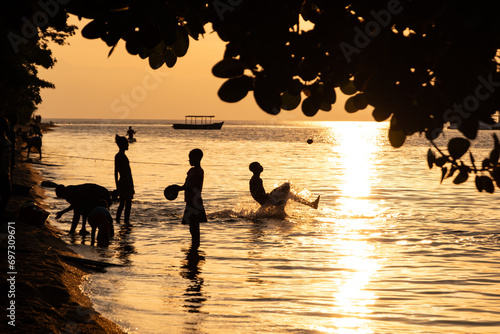 Kids playing at sunset over Lake Malawi in Cape Maclear, Malawi
