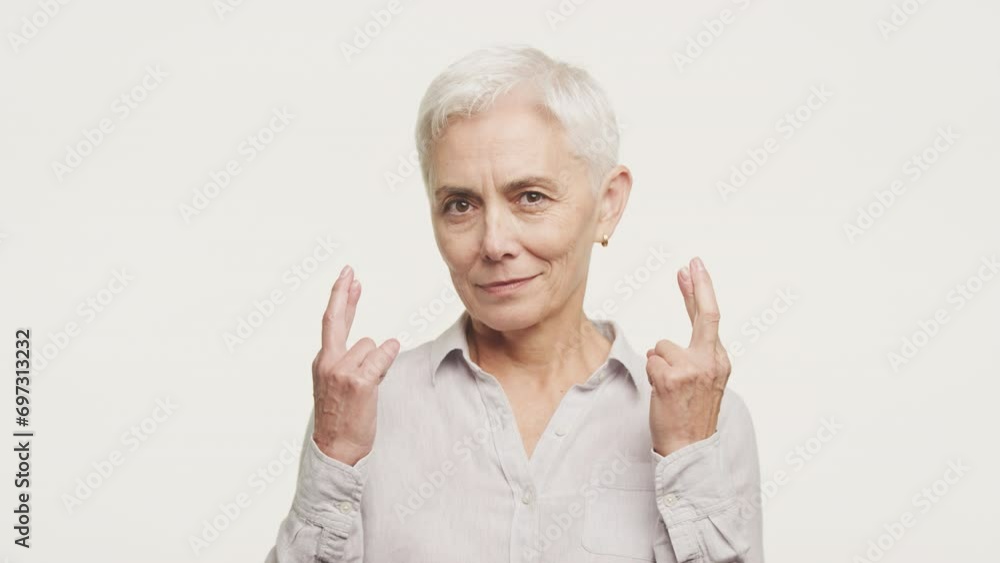 Hopeful Senior Woman with Crossed Fingers Hopeful Senior Woman with Crossed Fingers