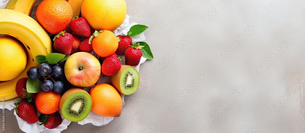Assorted fresh fruits in an eco-friendly bag on a tiled floor. Nutritious, vitamin-rich. Overhead view of juicy fruits. Assorted fresh fruits in an eco-friendly bag on a tiled floor. Nutritious, vitamin-rich. Overhead view of juicy fruits.