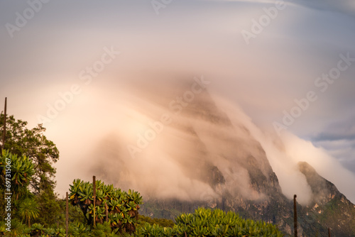 Morning mist across Mikeno volcano from Karisimbi volcano, Rwanda photo