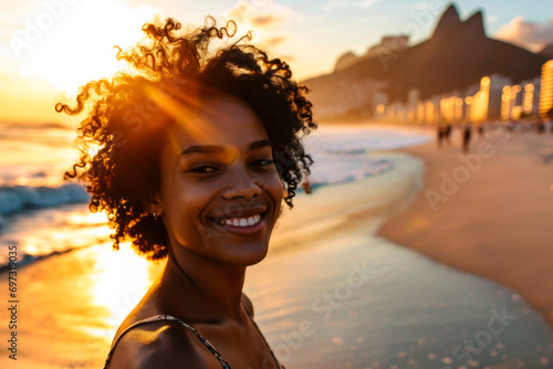 young brazilian afro hairstyle woman walking on the beach	 photo