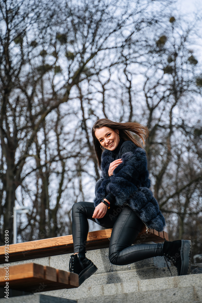 A Woman Enjoying a Relaxing Moment on a Cement Bench. A woman sitting on top of a cement bench A Woman Enjoying a Relaxing Moment on a Cement Bench. A woman sitting on top of a cement bench