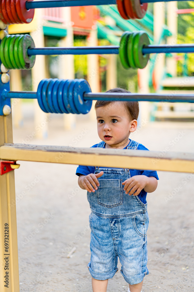 Little Boy Enjoying Playtime at the Playground. A little boy that is standing in front of a playground