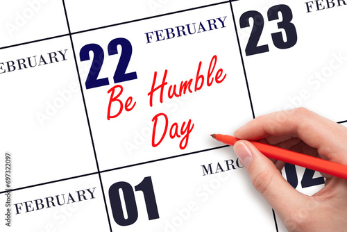 February 22. Hand writing text Be Humble Day on calendar date. Save the date.