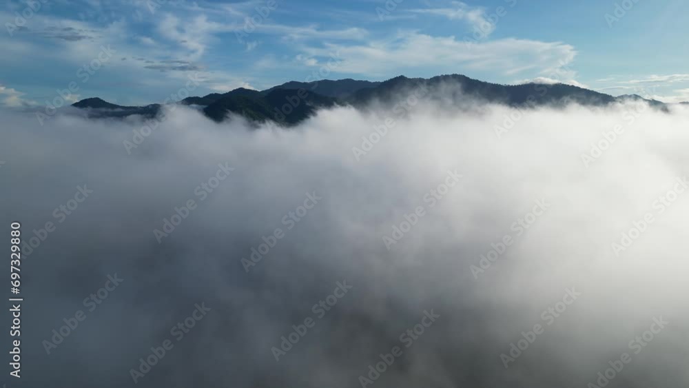 Bird's-eye view showcasing the tranquil beauty of a landscape with low clouds and rolling hills in the background Bird's-eye view showcasing the tranquil beauty of a landscape with low clouds and rolling hills in the background