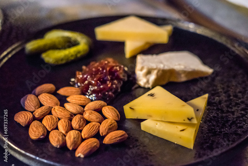 Cold cuts platter, variety of cheese with olives and nuts photo