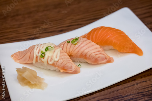Set of Salmon aburi sushi with sauce on plate