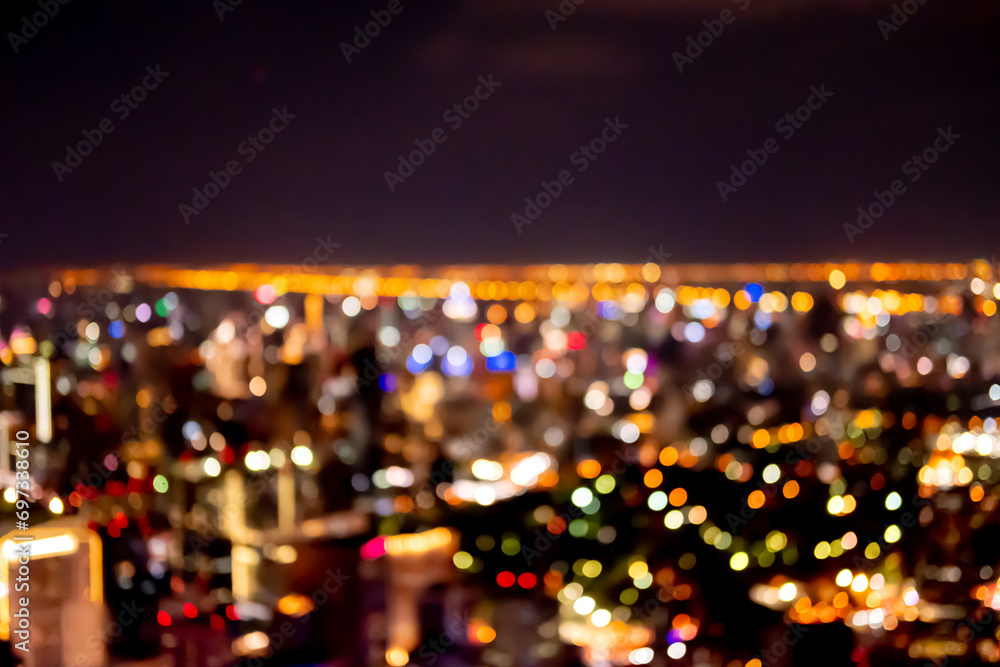 Blurred image bokeh of Bangkok cityscape, night top view in the business district in Thailand.