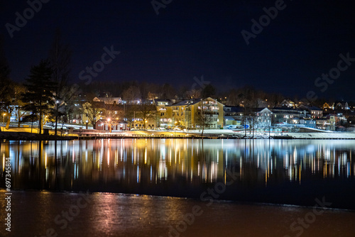 Skyline of Bengtsfors in Sweden at night and with reflection in the lake photo