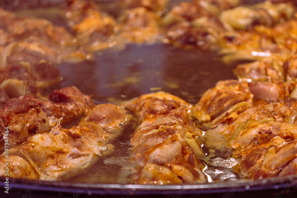 Food in a large round pan and grill placed on the counter and intended for sale in the market to customers. Food in a large round pan and grill placed on the counter and intended for sale in the market to customers.