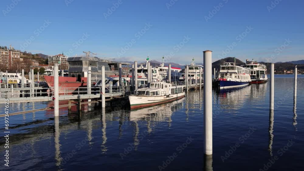 barche sul lagio maggiore ad arona in italia, boats on the lake maggiore in arona village in italy barche sul lagio maggiore ad arona in italia, boats on the lake maggiore in arona village in italy