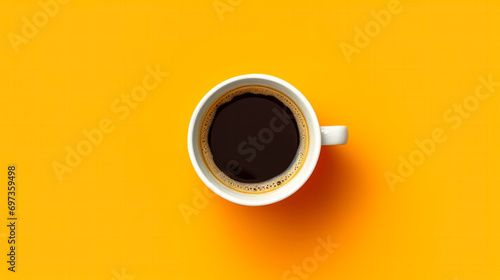 Top view of a white cup filled with aromatic coffee on a cheerful yellow background photo