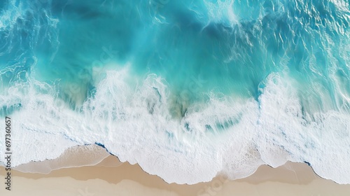 On a sunny day  a drone aerial view shows the beautiful waves and blue sea water of a summer seascape.