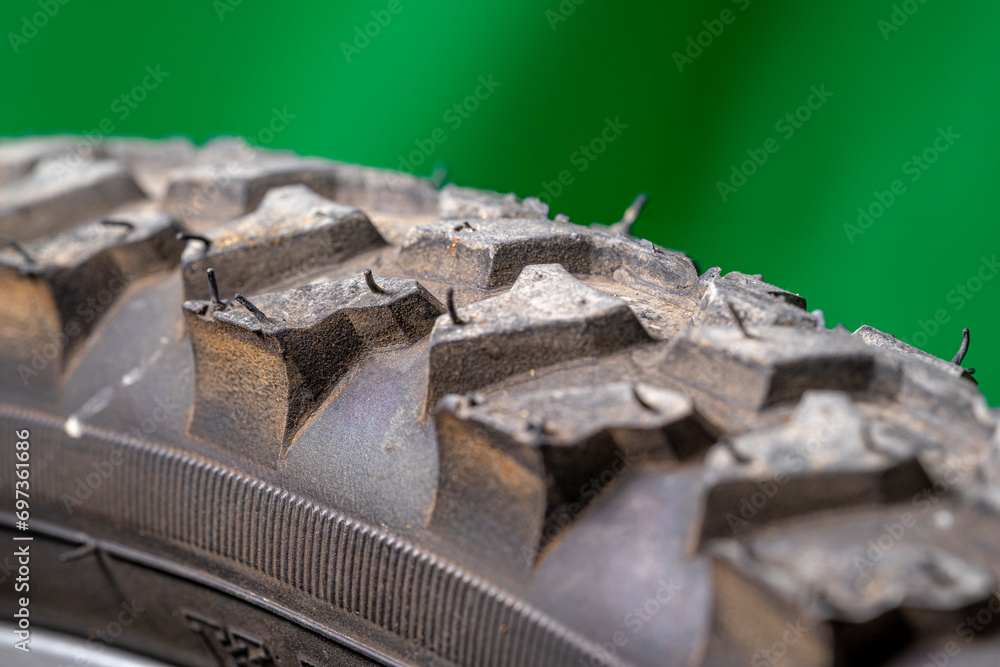detail of a black bicycle tire with fur on the surface. green background. detail of a black bicycle tire with fur on the surface. green background.